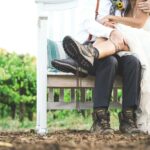 woman and man sitting on white wooden bench