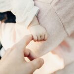 person holding baby's hand